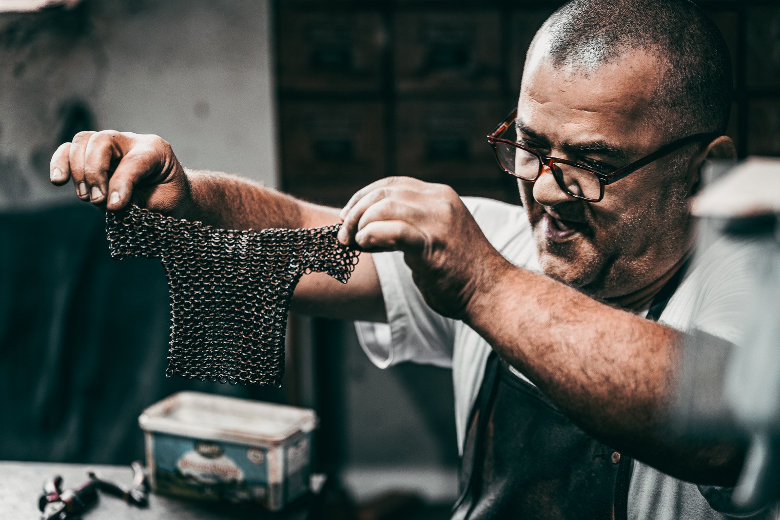 Craftsman working on chainmail armor in a traditional workshop, Istanbul, Turkey