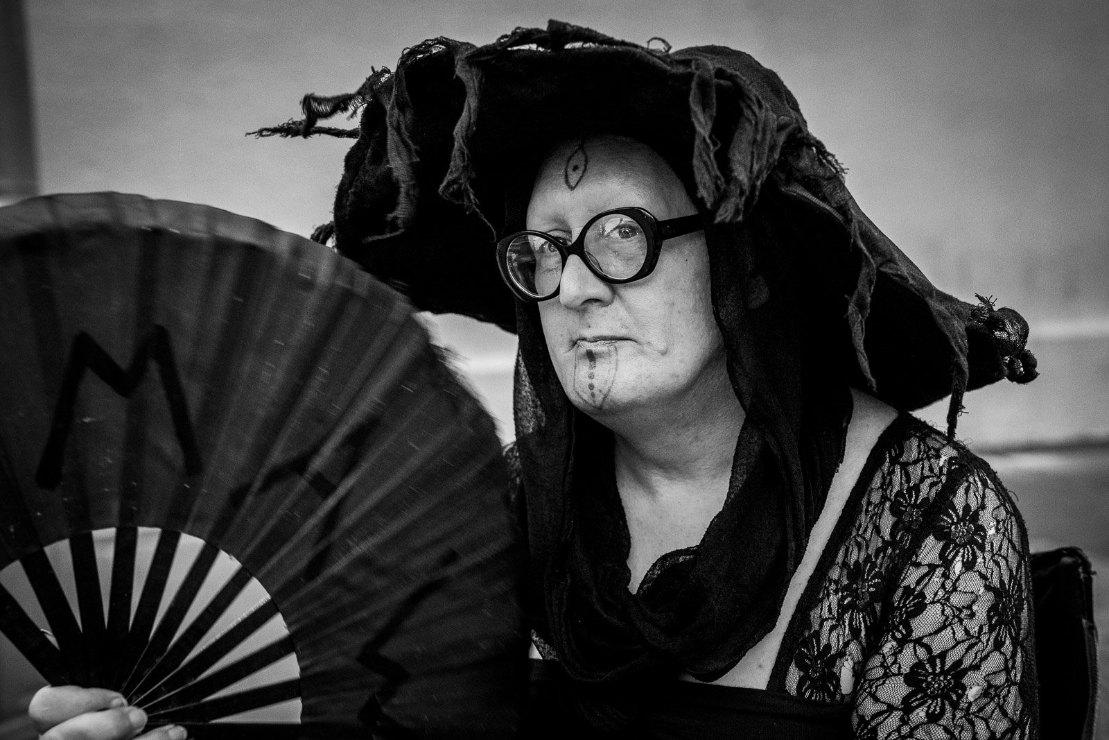 Portrait of a person holding a decorative fan, travel portrait photography