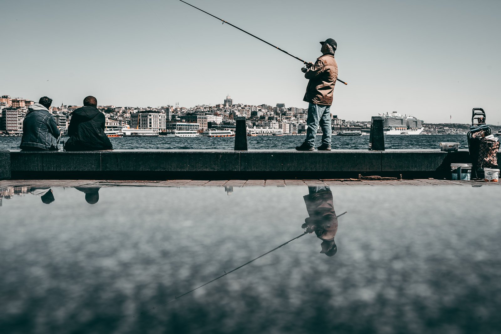Fishermen casting lines at dawn with mirror-like water reflections, Egypt