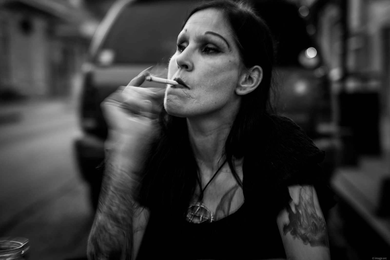 Black and white street portrait of a woman smoking a cigarette, Buenos Aires, Argentina