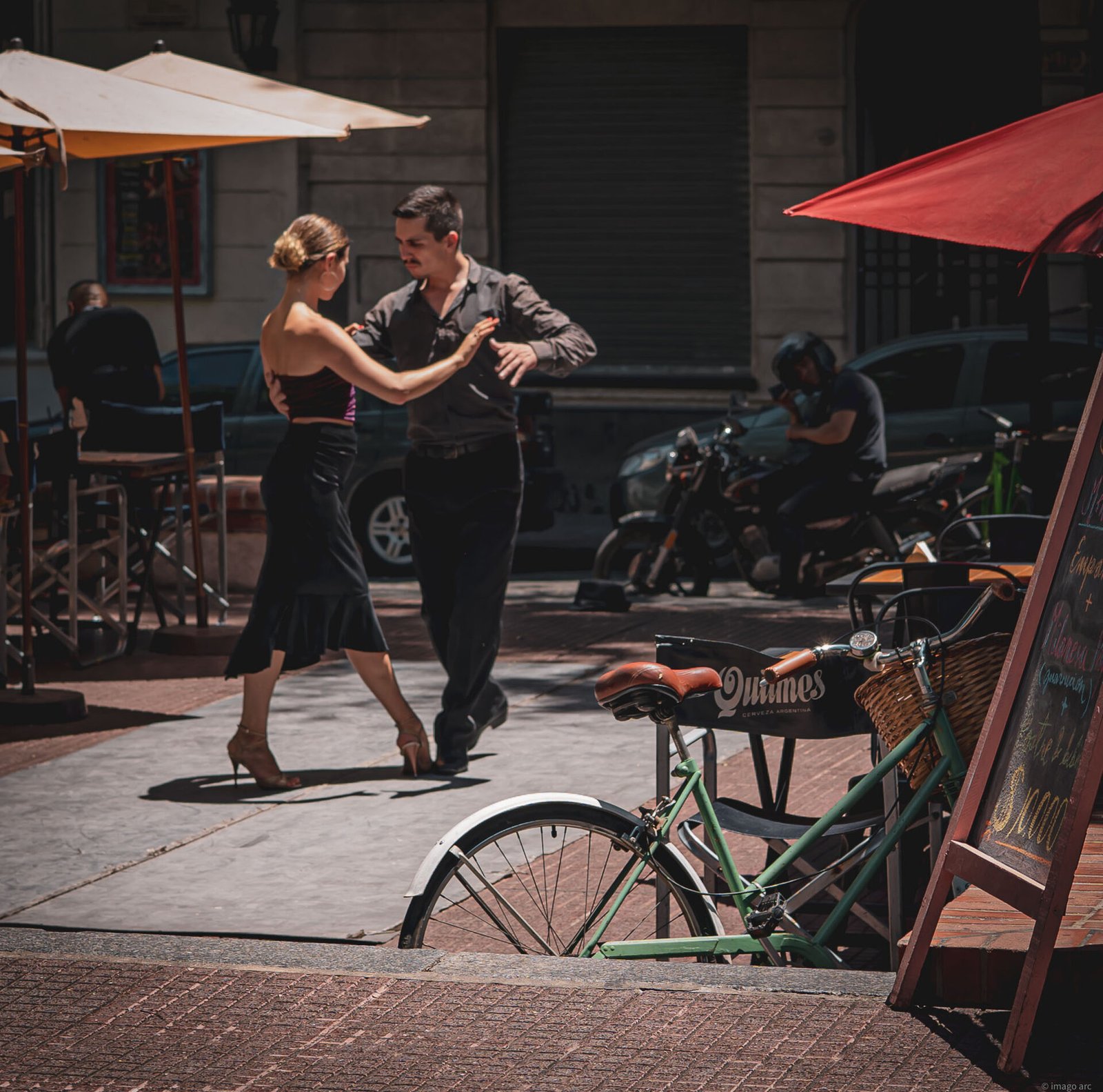 Couple dancing tango on a cobblestone street in San Telmo, Buenos Aires, Argentina