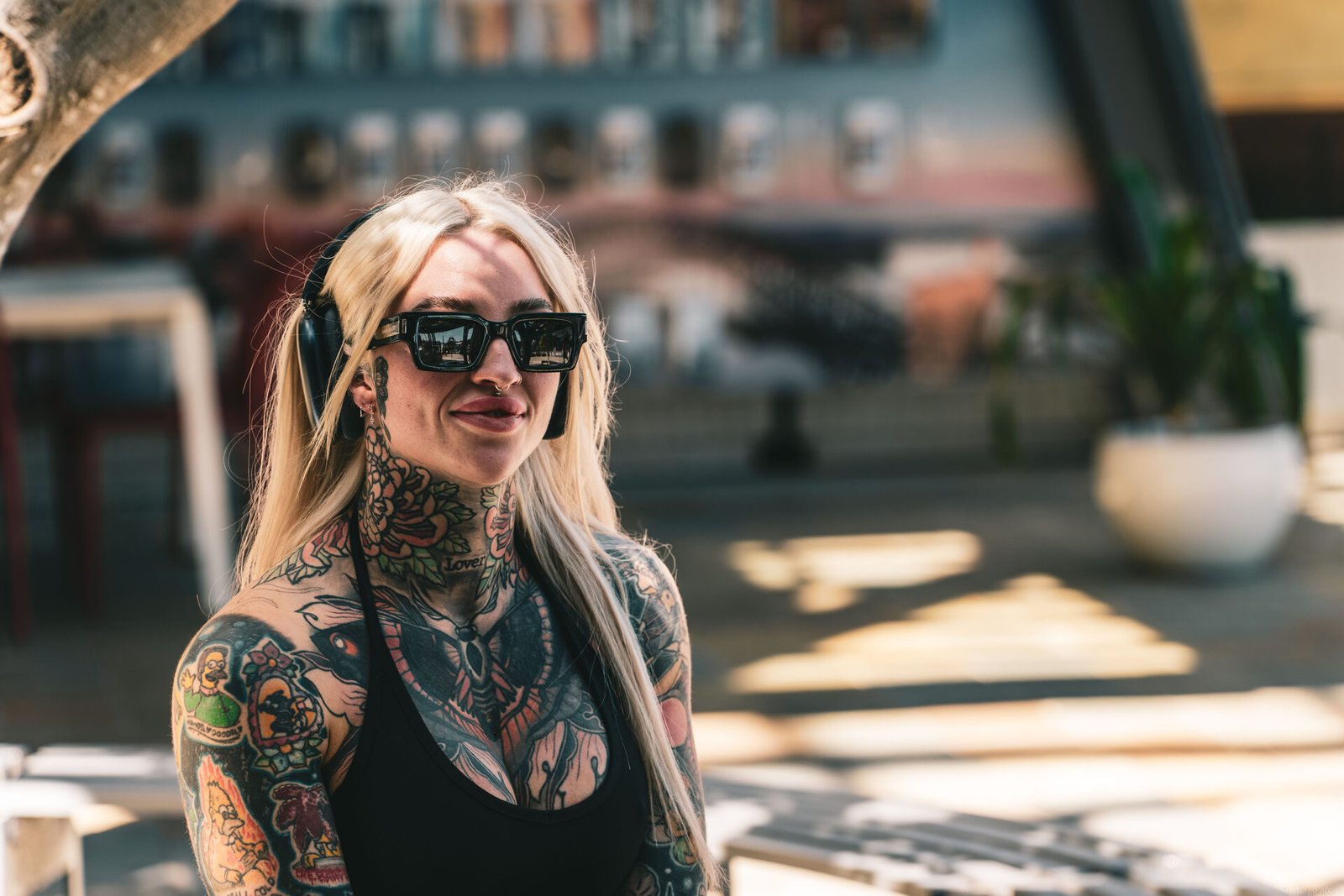 Portrait of a tattooed woman in dramatic natural light, documentary photography