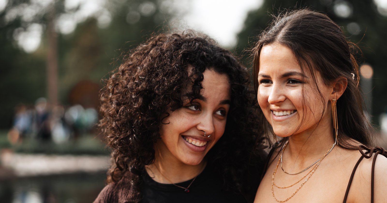 Two women sharing a laugh, candid street portrait photography
