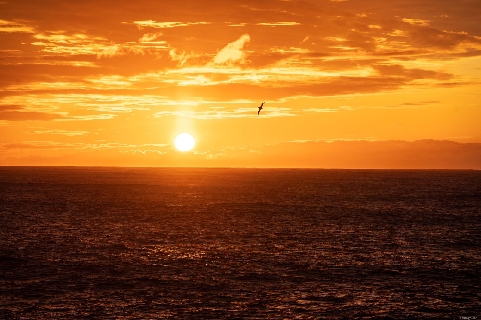 Dramatic ocean sunset with waves breaking on the shore, travel photography