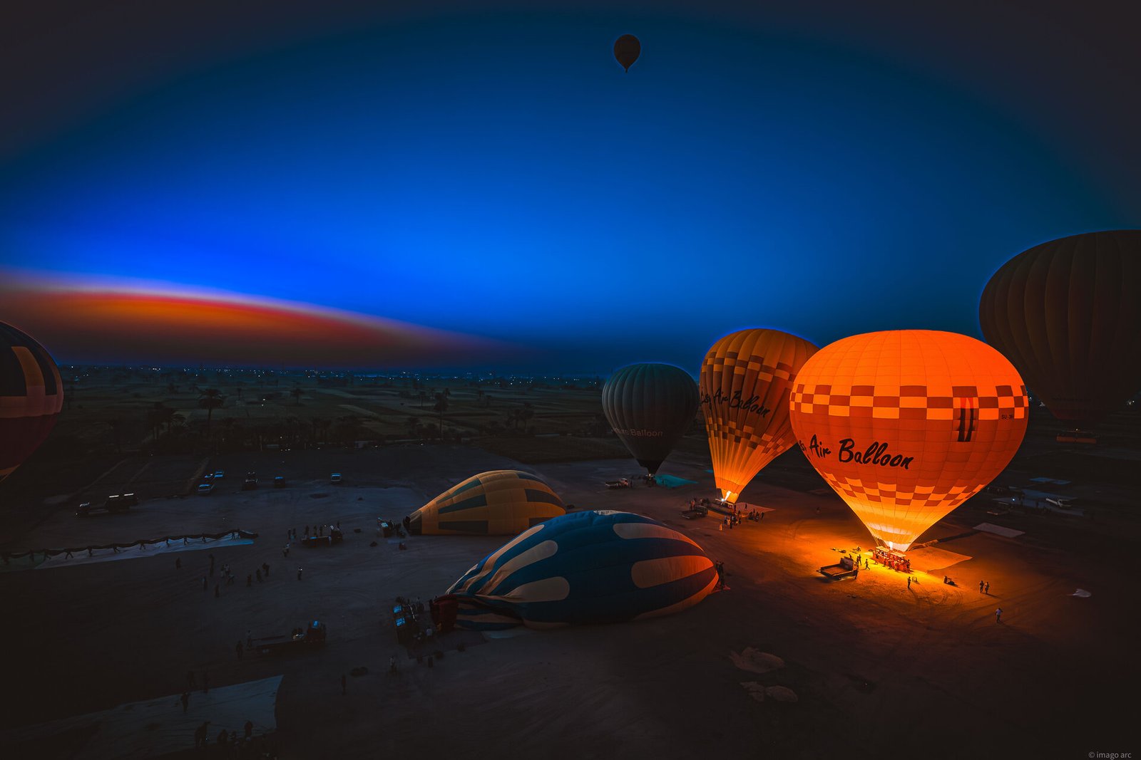 Hot air balloons rising at sunrise over the fairy chimneys of Cappadocia, Turkey