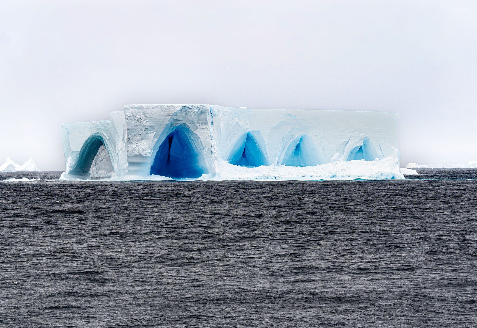 Blue ice caves carved into an Antarctic iceberg, Antarctica