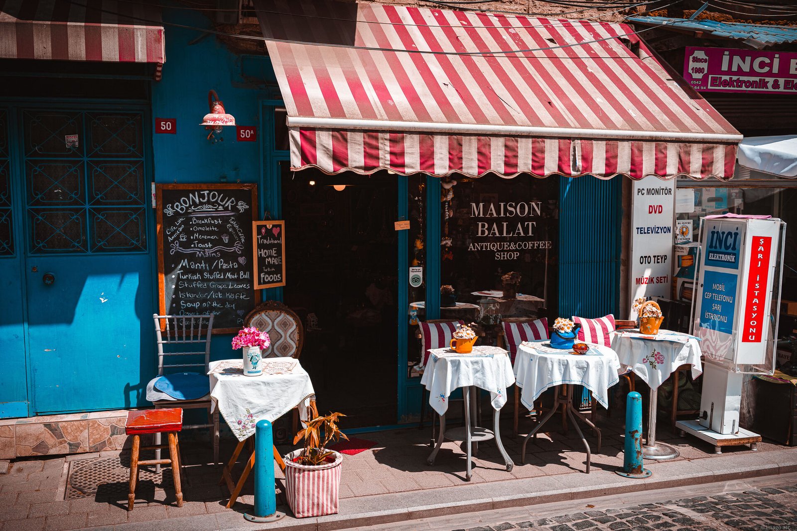 Traditional street cafe with patrons in the warm glow of evening, Istanbul, Turkey
